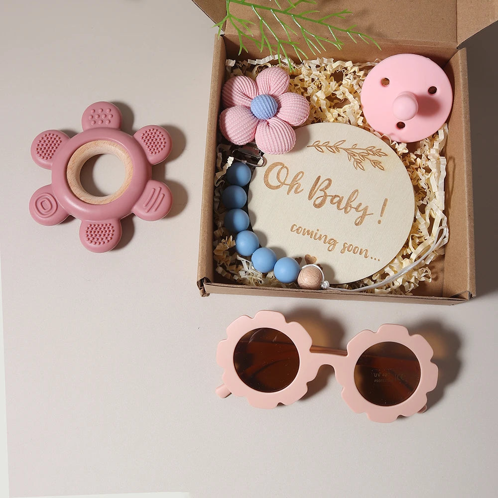 Flower Teether & Baby Sunglass Gift Set from Oliver & Company Montessori Toys, featuring a silicone teether, pacifier chain, and protective baby sunglasses. Ideal for teething relief and style.