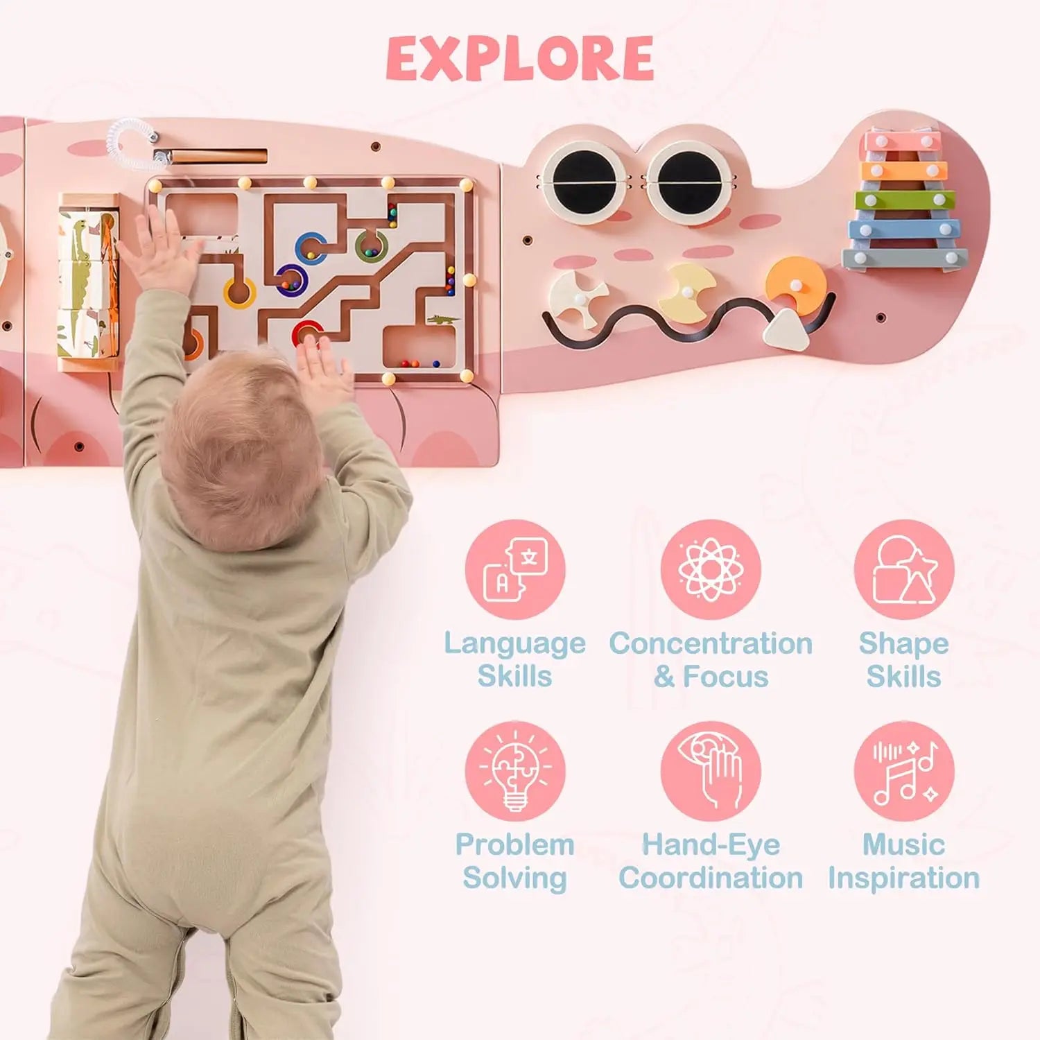 Child playing with a pink educational toy with various interactive elements, labeled 'EXPLORE'.