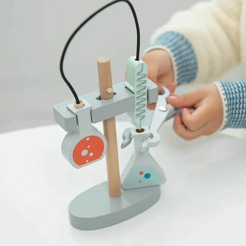 Pretend Play Microscope Set: A child interacts with a wooden toy microscope and tools, designed to inspire budding biologists through playful, educational exploration.