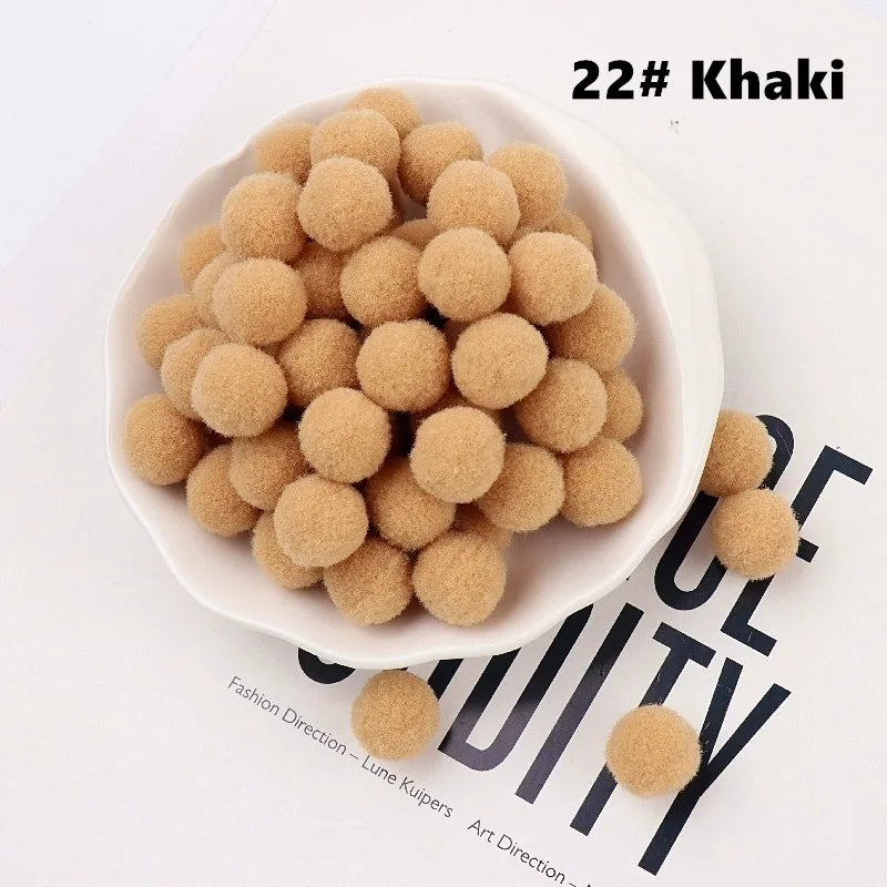 White bowl filled with beige pom-poms on a magazine background
