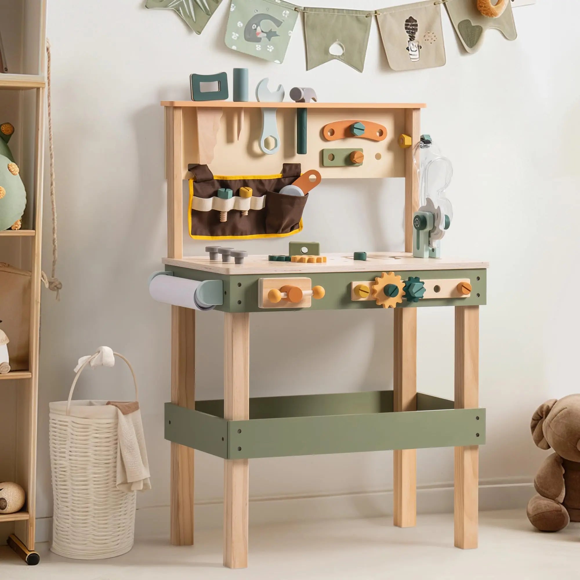 Children's play kitchen set with various toy tools and accessories in a room setting.