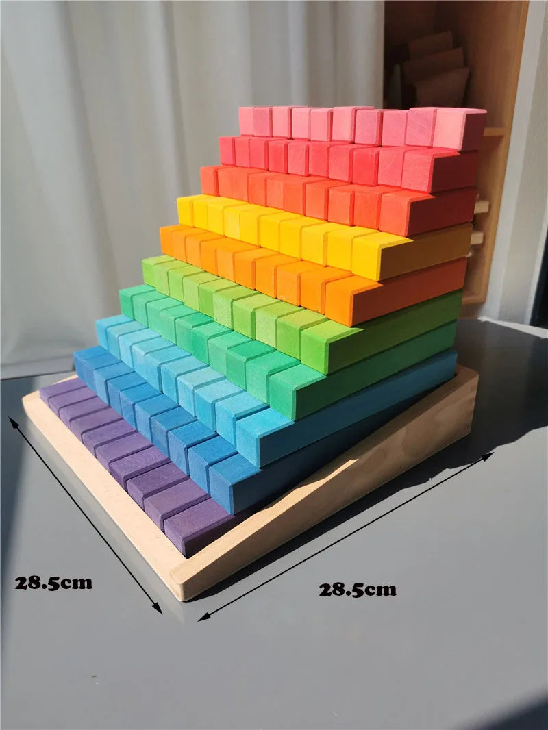 Colorful wooden block tower with measurements on a gray surface