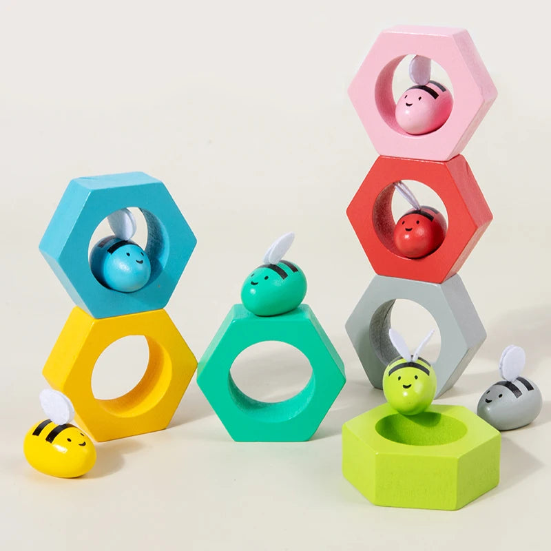 Colorful wooden toys with hexagonal shapes and small animal figures on a light background