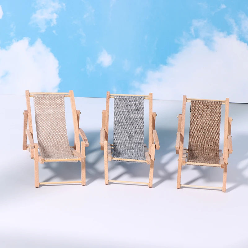 Three wooden deck chairs with woven seats against a blue sky background