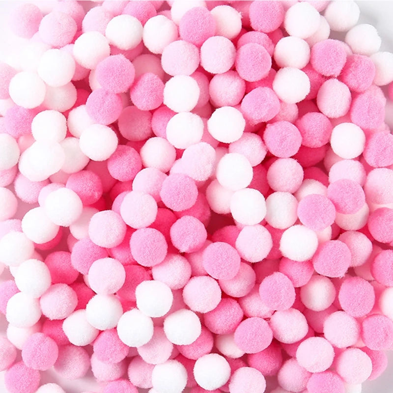 Pink and white foam pom-poms scattered together