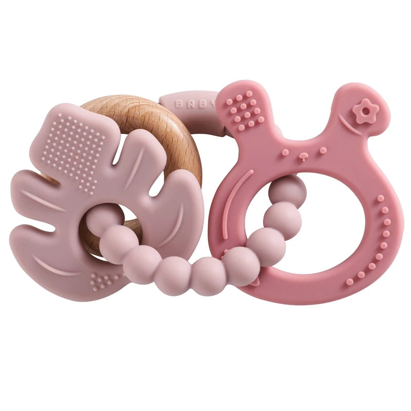 Two pink baby teething rings with different textures on a white background