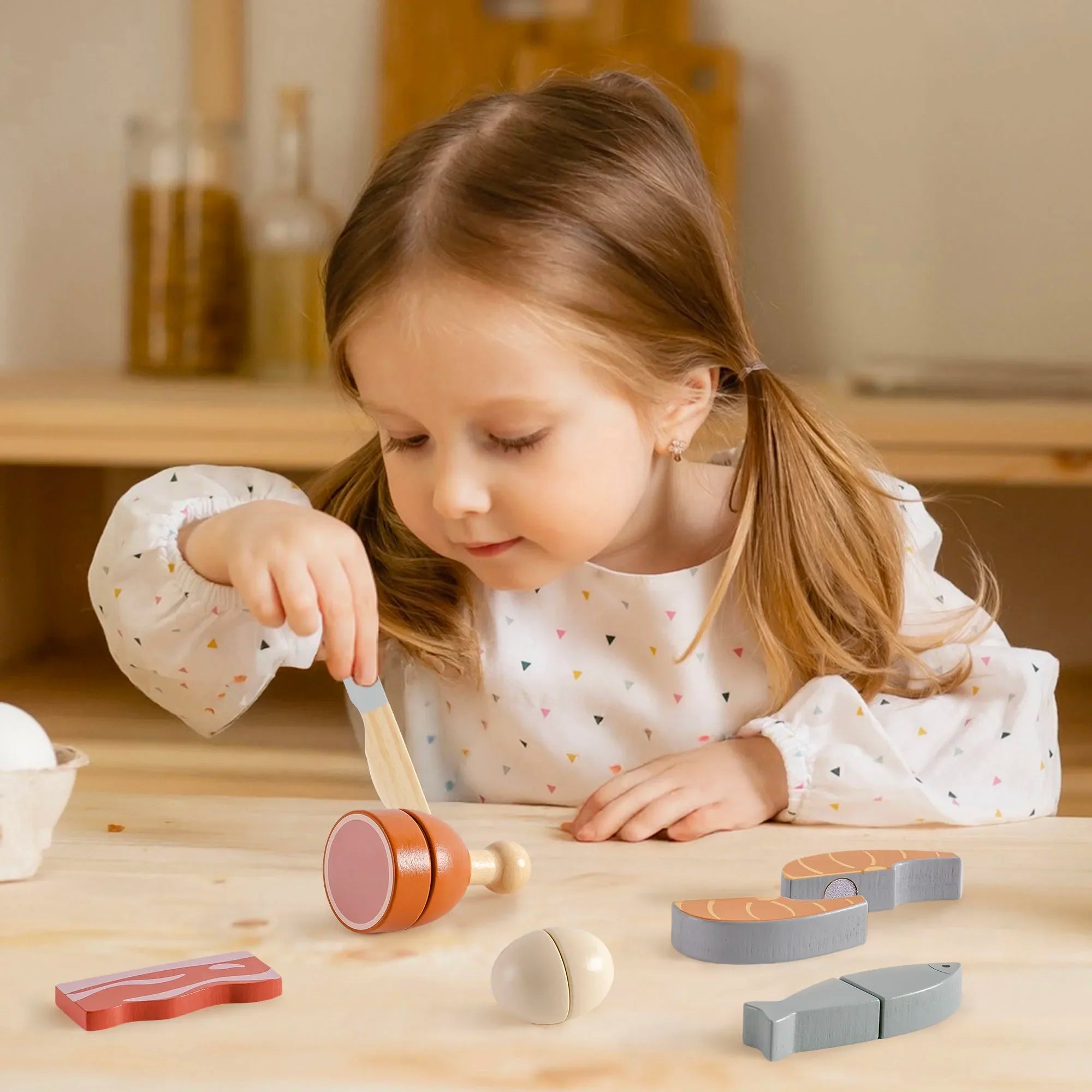 Young girl playing with wooden toys on a table