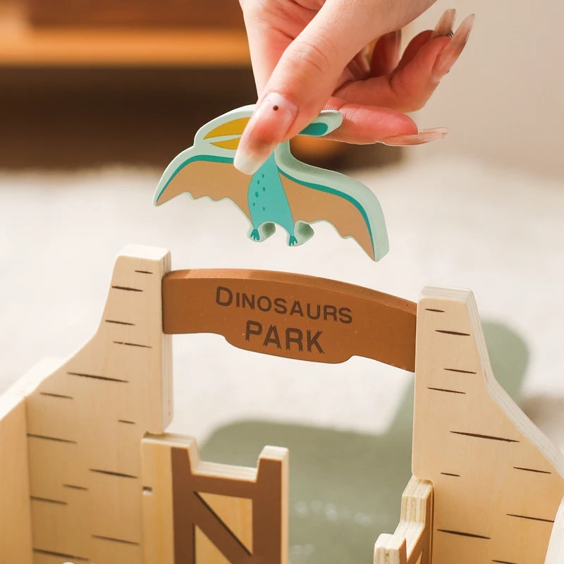 Montessori Dinosaur Park Busy Box with stacking blocks and foldable scene.