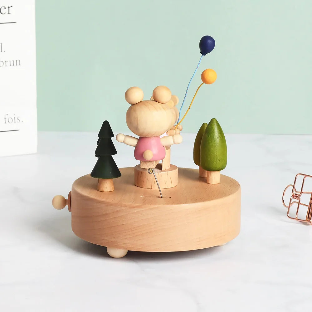 Wooden toy with a bear character and balloons on a white surface