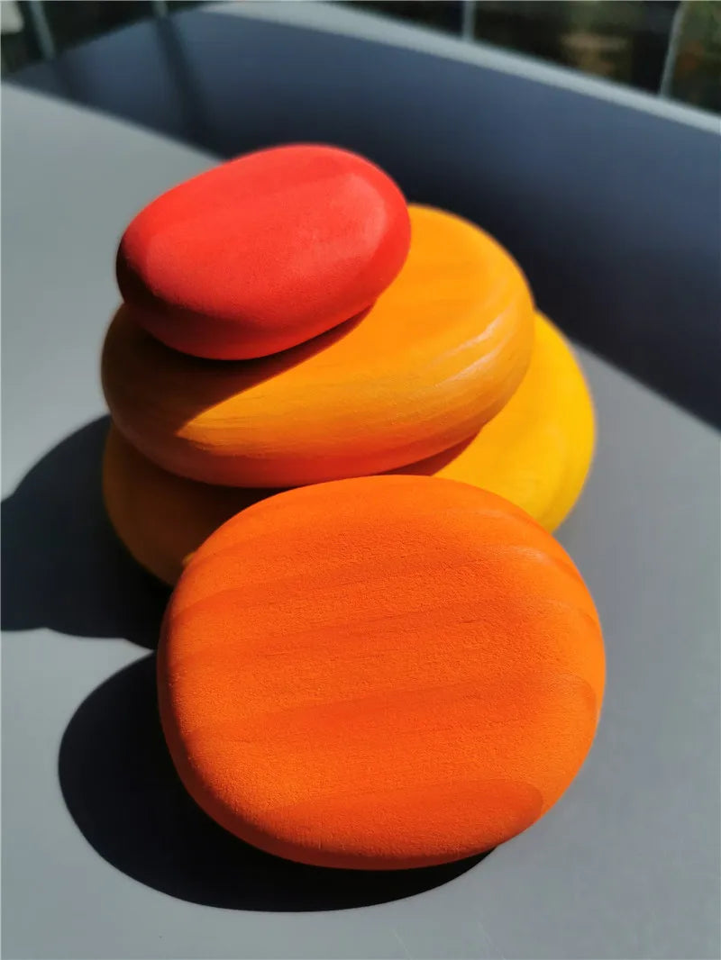 Stack of colorful round objects on a reflective surface