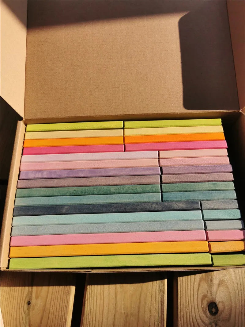 Box of colorful rectangular blocks on a wooden surface