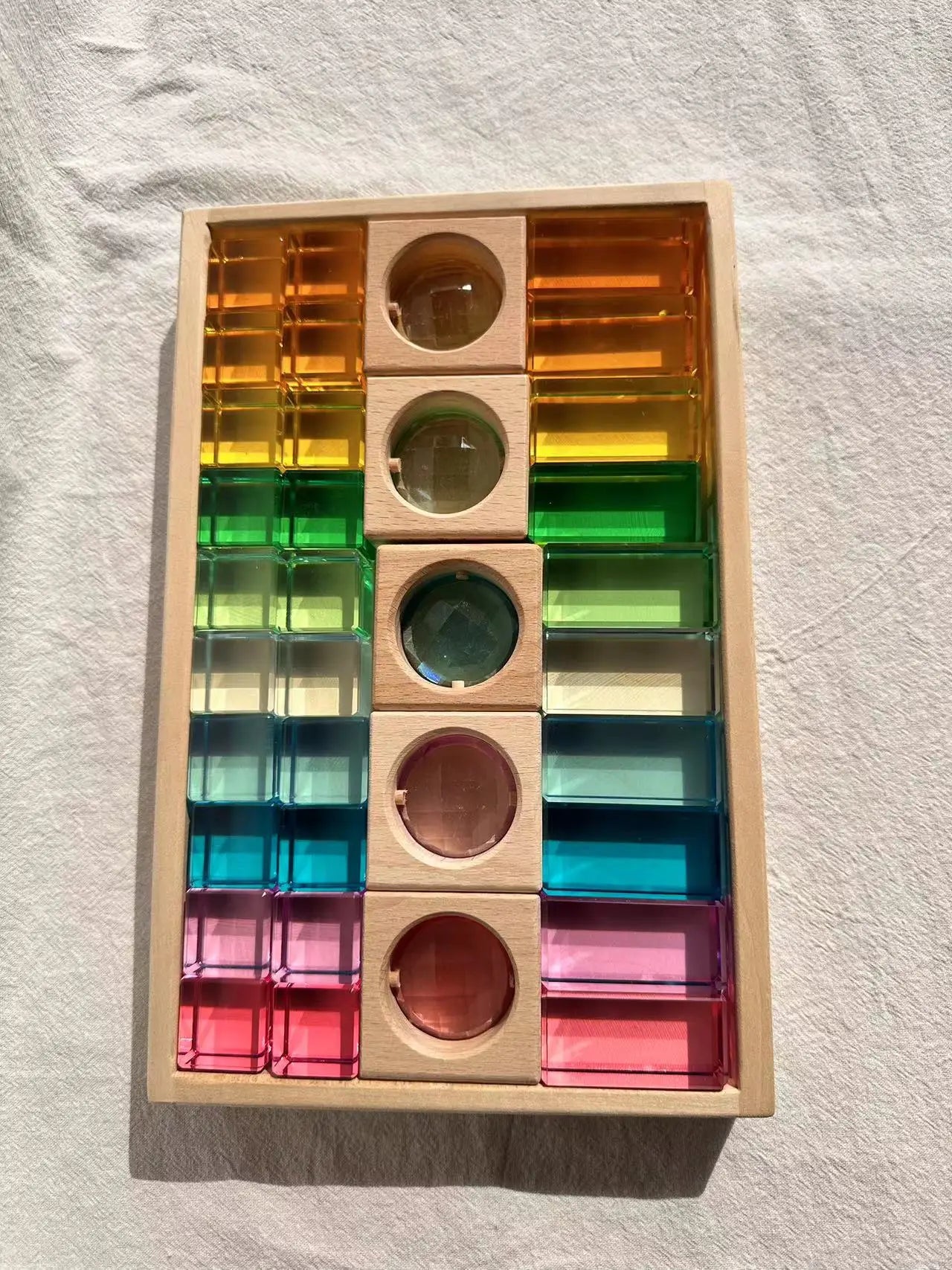 Colorful wooden puzzle toy with transparent acrylic pieces on a textured surface