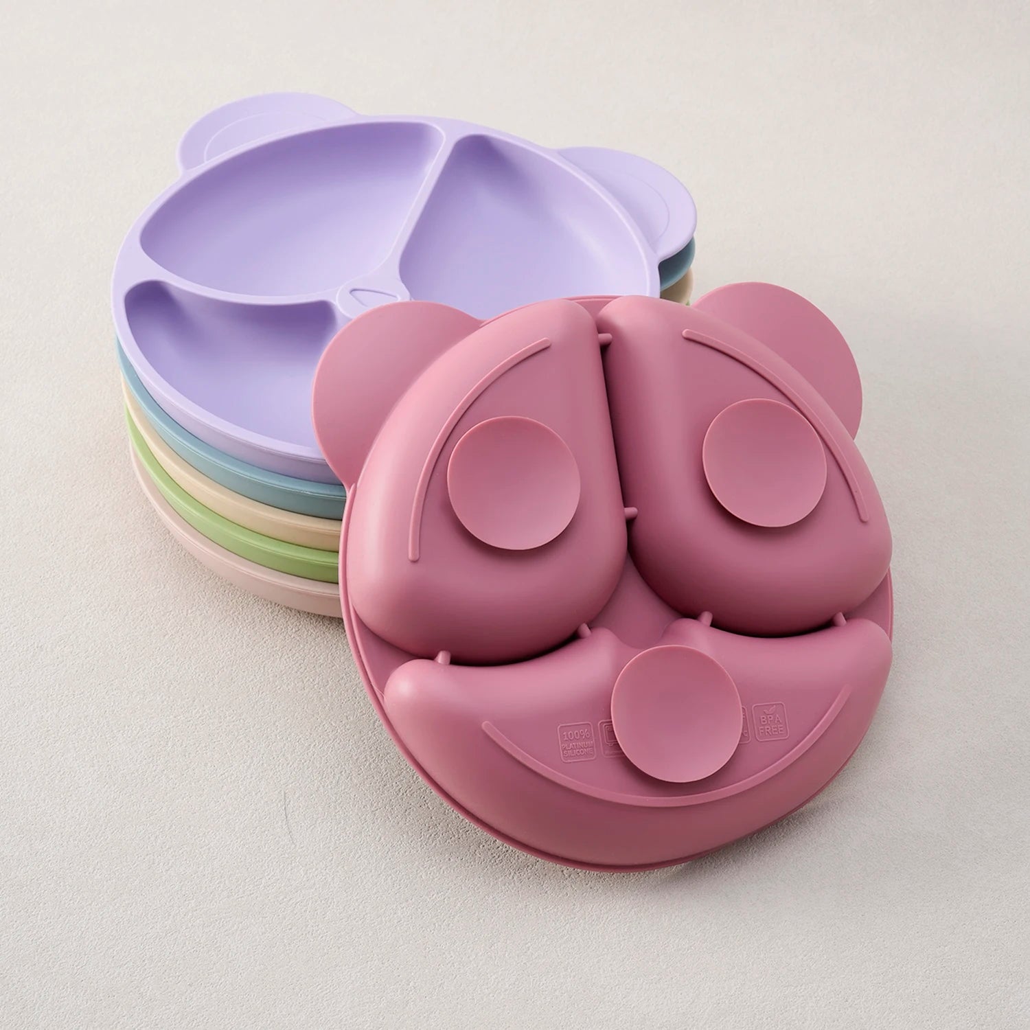 Stack of silicone bear plates showing the suction base