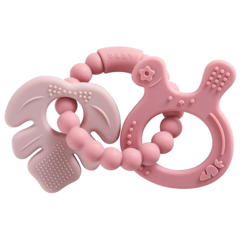 Pink silicone teething ring with textured surface on a white background