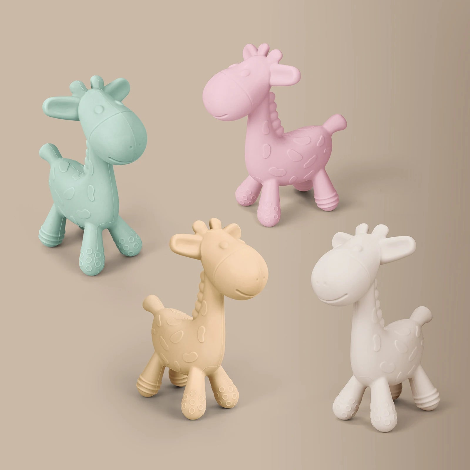 Four giraffe-shaped toys in different colors on a beige background