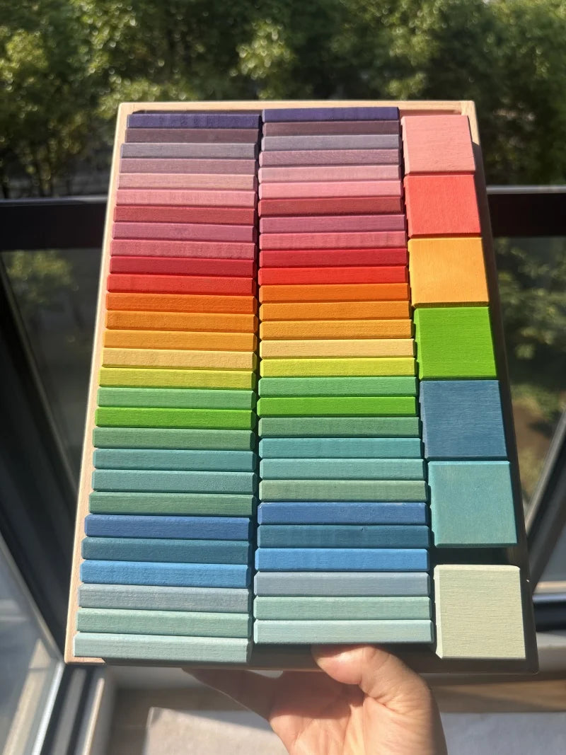 Color swatch chart held by a hand with a blurred outdoor background