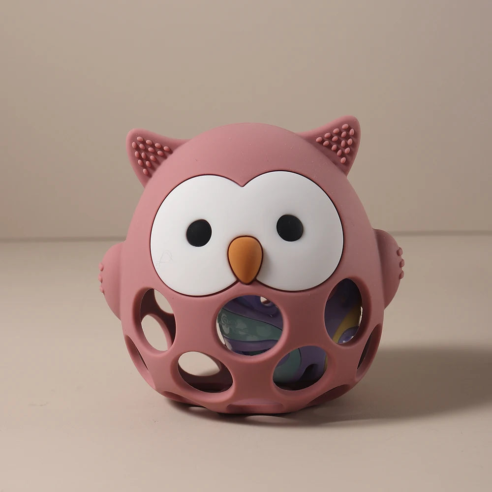 Pink owl-shaped toy with a textured surface on a beige background