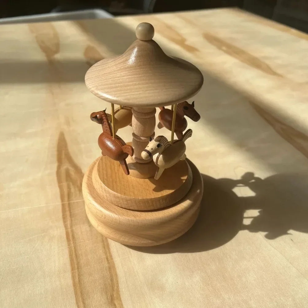 Wooden carousel toy with horses on a wooden surface