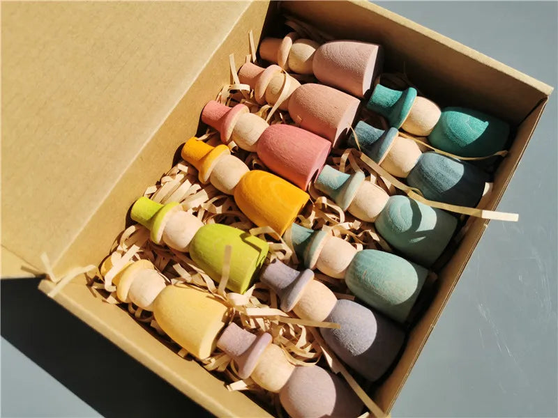 Colorful wooden toys in a box on a gray background