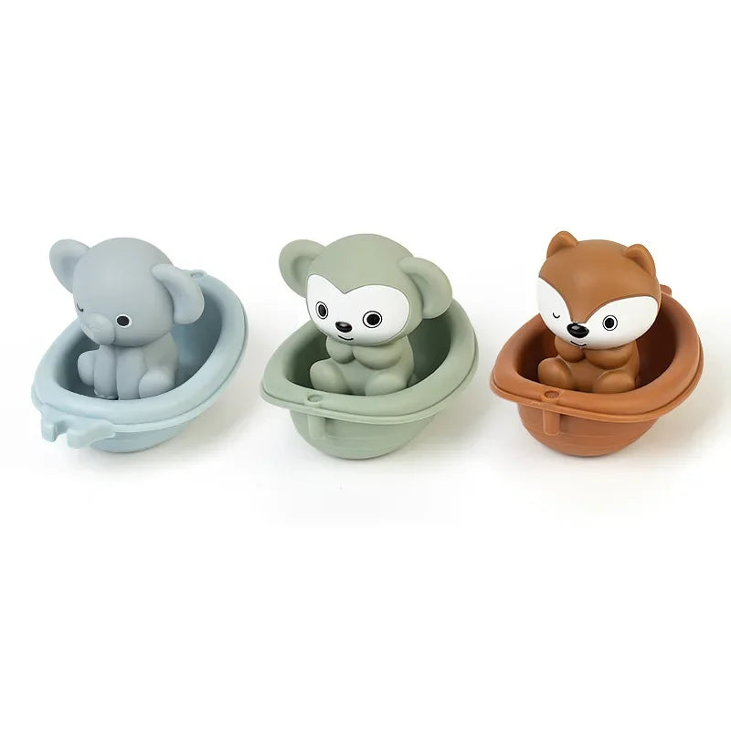 Three animal-themed bath toys in different colors on a white background