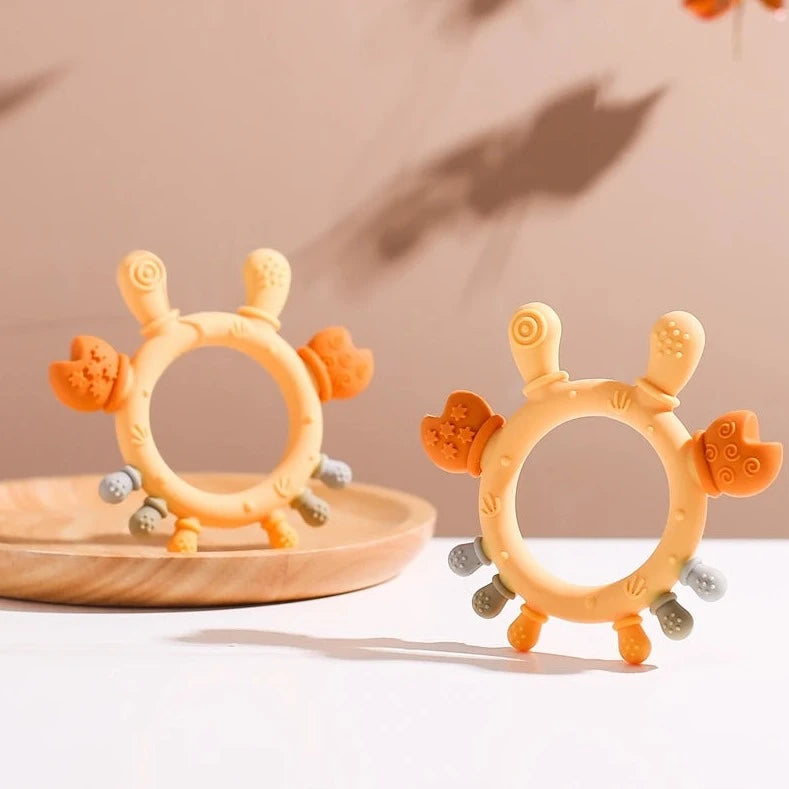 Cartoon Crab Baby Teething Toy on a table, designed for soothing gums and visual stimulation, ideal for newborns' dental growth and sensory exploration.