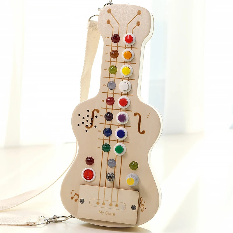 Colorful wooden toy guitar with buttons on a white background