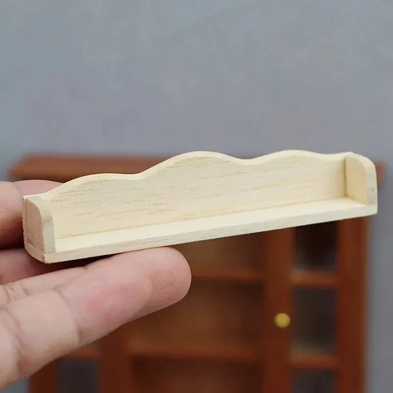 Small wooden shelf held in a hand against a blurred background