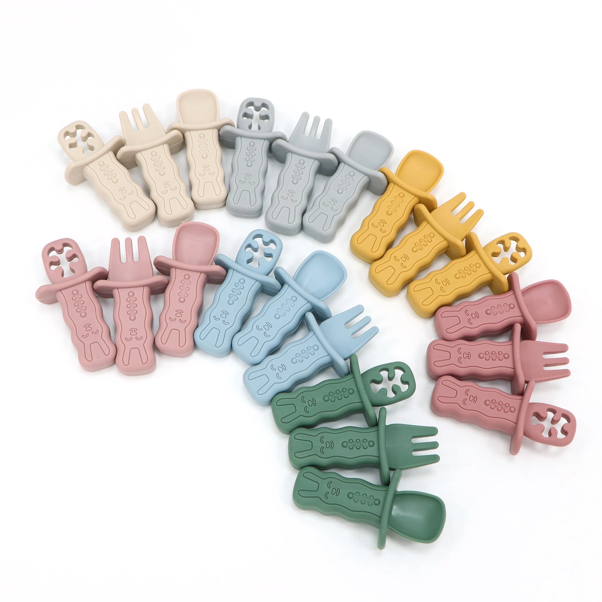 Set of colorful baby utensils on a white background