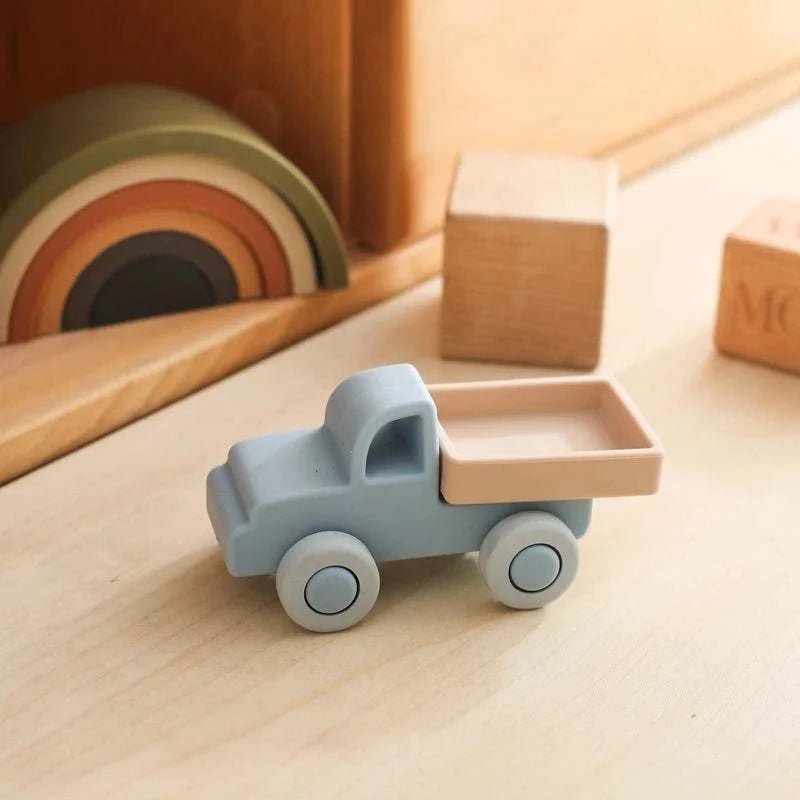 Baby Silicone Car Toy on a table, showcasing a toy vehicle designed for infants to encourage sensory exploration and fine motor skills through Montessori-inspired play.