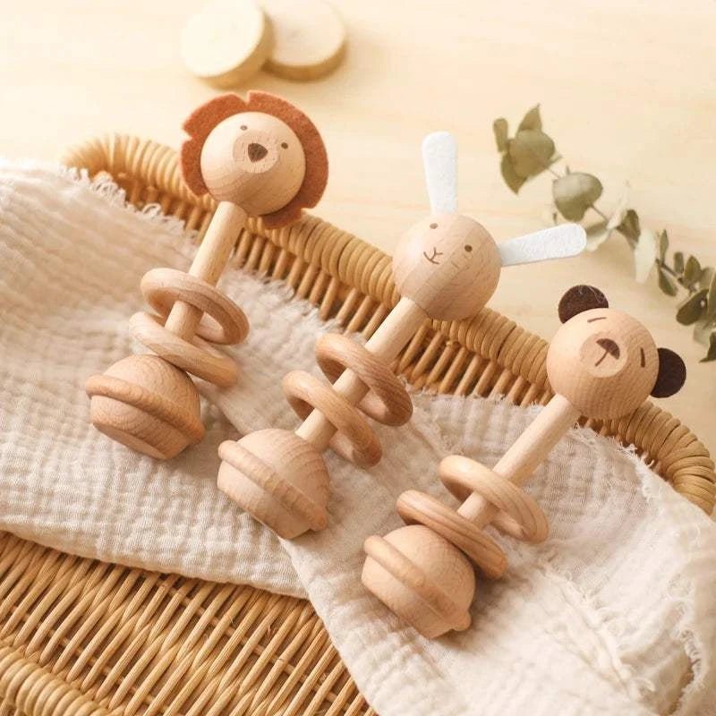 Baby Wooden Character Rattles in a basket, featuring adorable lion, rabbit, and bear designs, perfect for sensory development and easy for little hands to grasp.