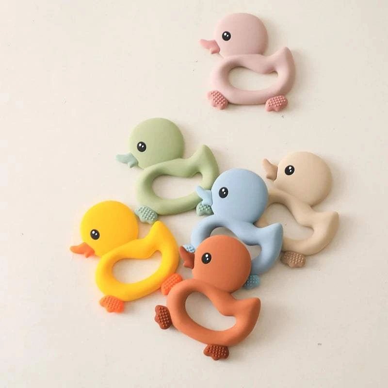 Duck Silicone Teether for Newborns (0-12 Months) featuring a group of rubber duck-shaped teething toys, perfect for soothing and entertaining babies during teething.