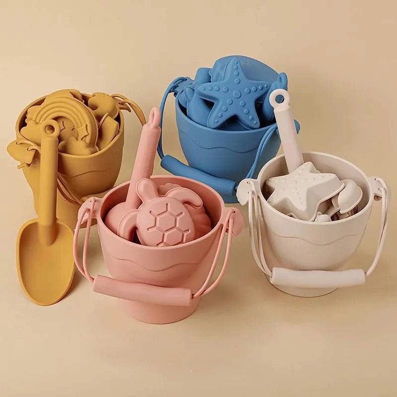 Eco-Friendly Silicone Beach Toys Set with various buckets and toy shapes, perfect for creative outdoor play, promoting sustainable fun for children.