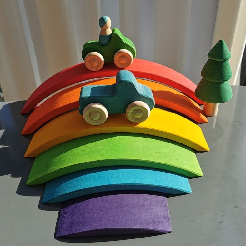 Montessori Basswood Rainbow Stacking Bridge, Cars, and Forest Trees Set featuring a colorful wooden rainbow, a toy car, and a green cone-shaped tree for imaginative play.