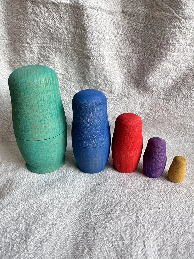 Montessori Beech Wood Rainbow Stacking Dolls: Nesting collectibles crafted from beech wood for size exploration and fine motor skill development through stacking.