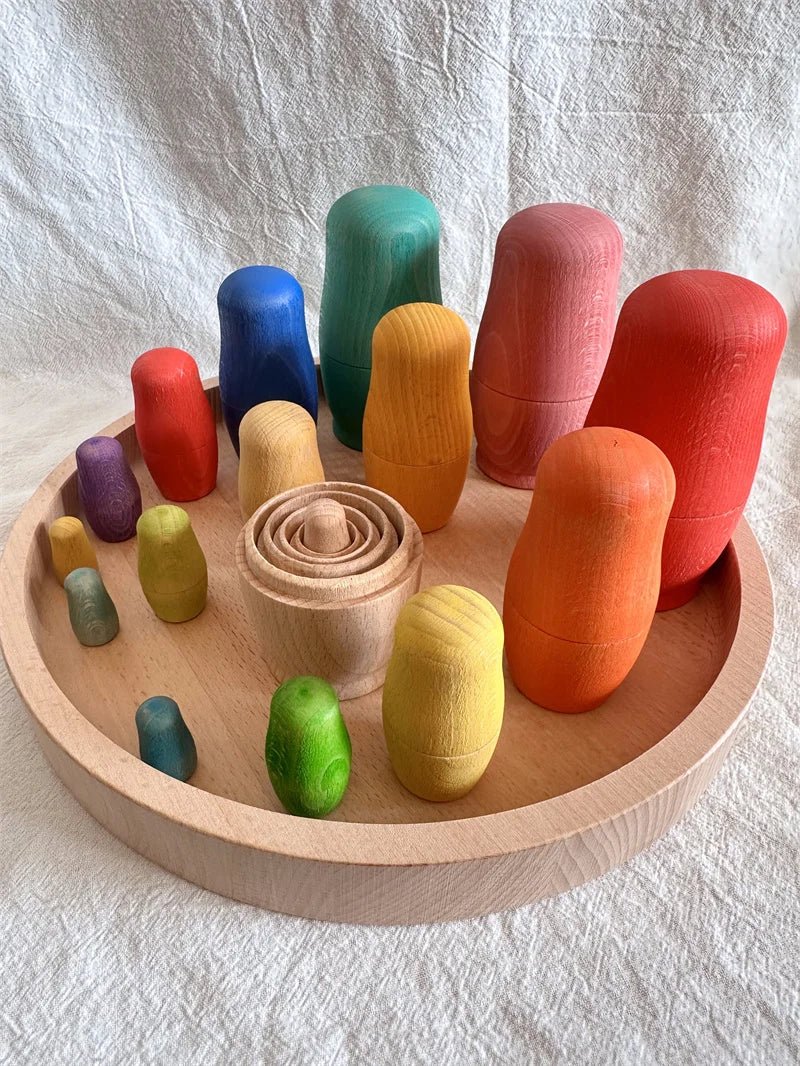 Montessori Beech Wood Rainbow Stacking Dolls on a wooden plate, showcasing their natural beech wood construction and spiral tops for creative play.
