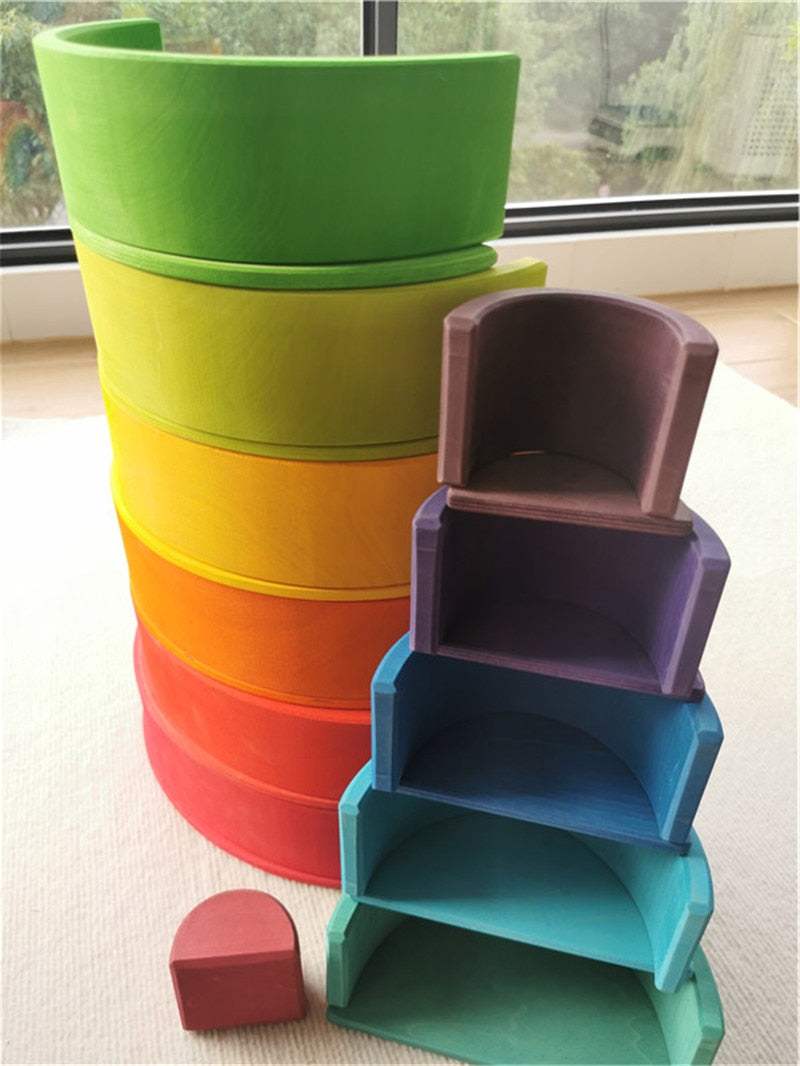 Montessori Deluxe Wooden Stacking Set with Peg Dolls and Matching Balls, featuring vibrant basswood blocks, arches, slats, and balls for open-ended play and learning.