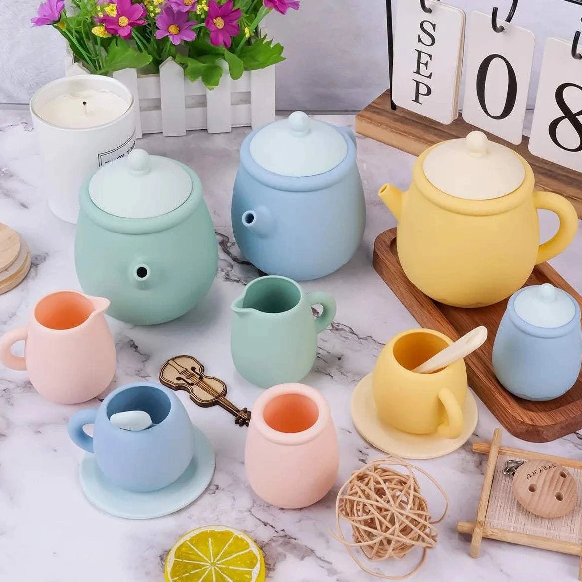 Montessori Interactive Tea Party Set featuring teapots, cups, and a pitcher, designed for imaginative play and sensory development, enhancing creativity and social skills in children.