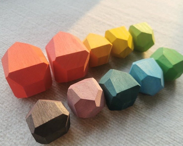 Montessori Large Wooden Balancing Stones for tactile play, featuring various shapes and sizes made of beech and pine wood, ideal for promoting balance and spatial awareness.