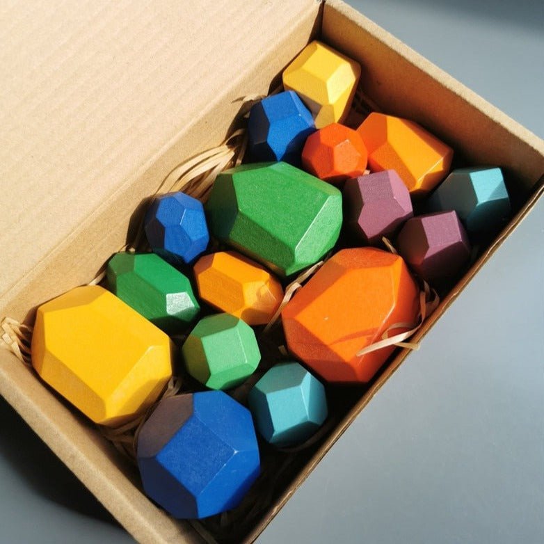 Montessori Large Wooden Balancing Stones in a box, featuring various geometric shapes designed for tactile play, promoting balance and spatial awareness in children.