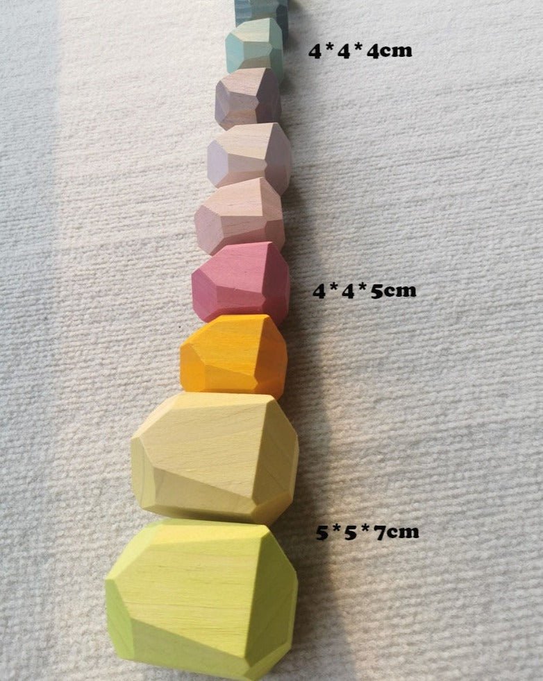 Montessori Large Wooden Balancing Stones in various sizes, designed for tactile play and learning balance, shown in a row to illustrate stacking possibilities.