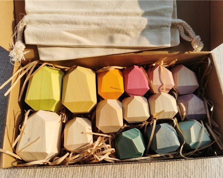 Montessori Large Wooden Balancing Stones in a box, designed for tactile play, enhancing balance and spatial skills in children. Made from beech and pine wood.