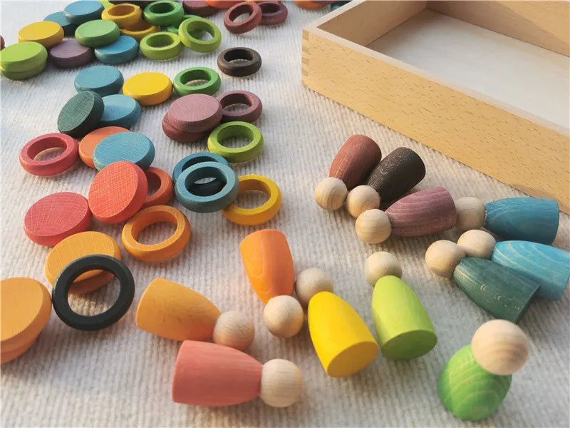Montessori Rainbow Stacking Coins and Rings with Peg Dolls, featuring beech wood figures for stacking and imaginative play, enhancing motor skills and coordination.