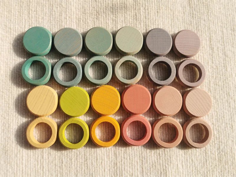 Montessori Rainbow Stacking Coins and Rings with Peg Dolls on display, showcasing colorful stackable elements for fine motor skills and imaginative play.