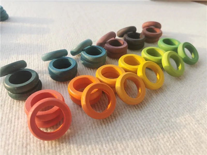 Montessori Rainbow Stacking Coins and Rings with Peg Dolls, showcasing colorful stackable rings and coins designed for developing fine motor skills and imaginative play in children.