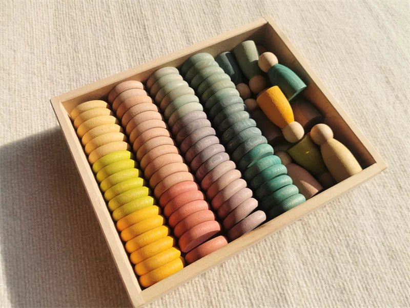 Montessori Rainbow Stacking Coins and Rings with Peg Dolls displayed in a wooden box, showcasing colorful rings, coins, and peg dolls for fine motor skill development.