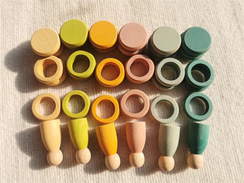 Montessori Rainbow Stacking Coins and Rings with Peg Dolls set, featuring wooden figures and stackable elements, designed to enhance children's fine motor skills and coordination.