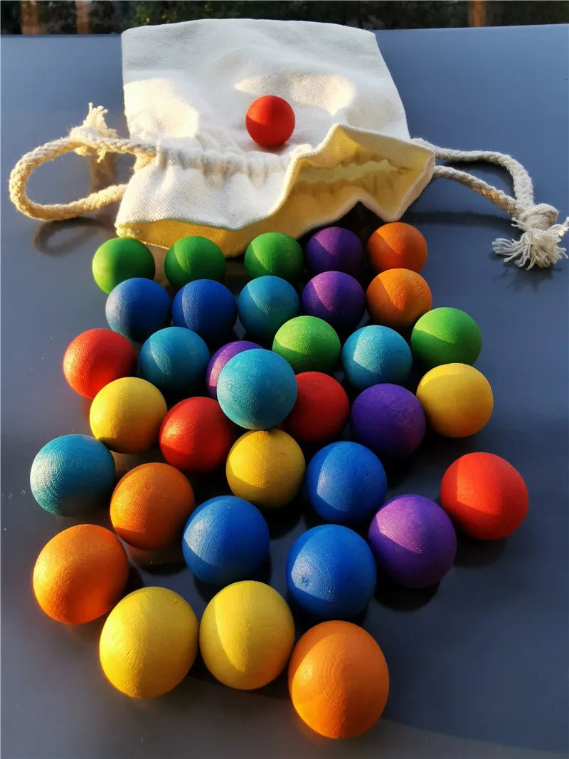Montessori Rainbow Stain Wooden Marbles in a bag, showcasing a vibrant collection of colorful wooden balls designed for sensory play and developmental activities.