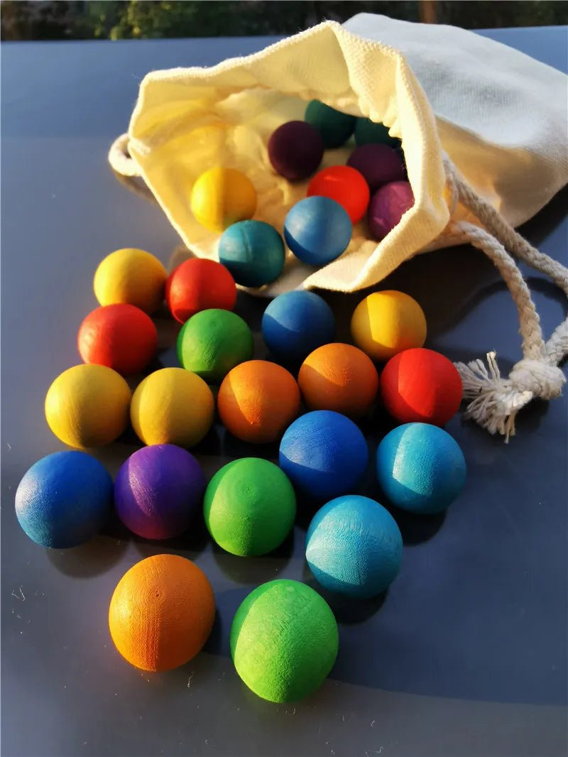 Montessori Rainbow Stain Wooden Marbles, a set of vibrant wooden balls perfect for sensory play and skill development, displayed in a playful, colorful arrangement.