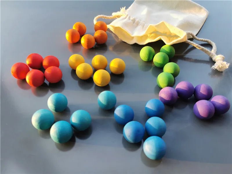 Montessori Rainbow Stain Wooden Marbles set of colorful wooden balls displayed on a table, perfect for sensory play and motor skill development.