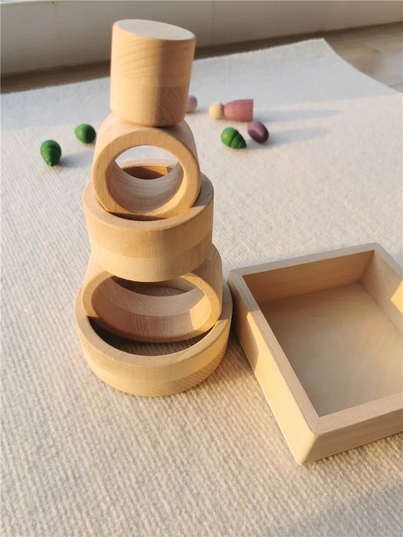 Montessori Rainbow Wooden Nesting Rings: Stacking Blocks. A stack of wooden rings designed for creative and educational play, fostering imagination and fine motor skills in children.